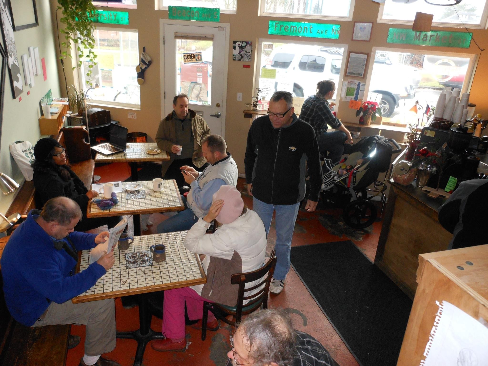 Crowded room with vintage street signs and tiled tables