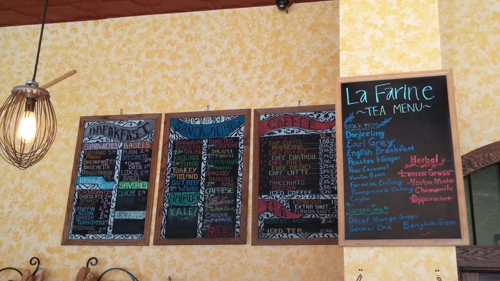 Framed chalkboard menus for breakfast, sandwiches, coffee and tea