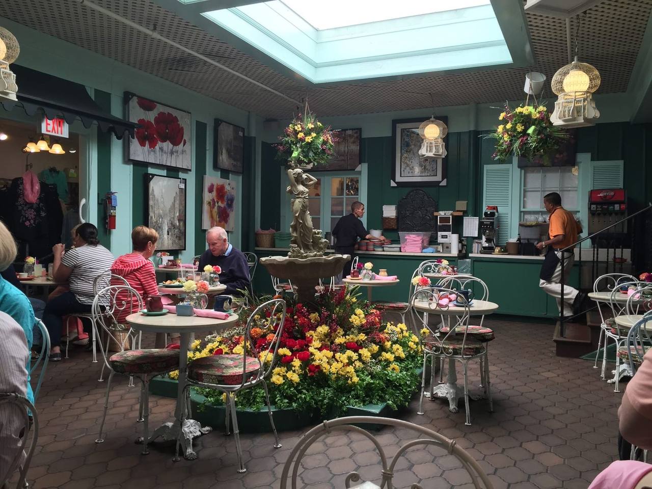 Skylit atrium with stone fountain, flower bed and diners