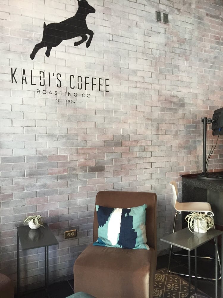Leaping goat logo painted above armchair with patterned throw pillow