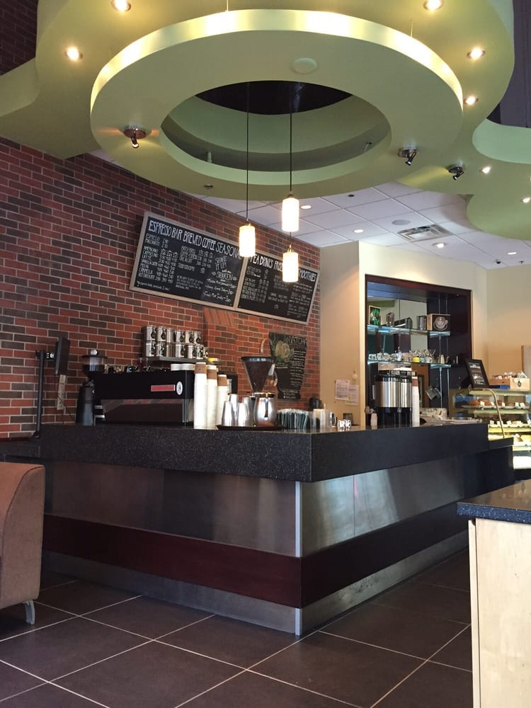 Service counter under circular green ceiling soffit with pastry case