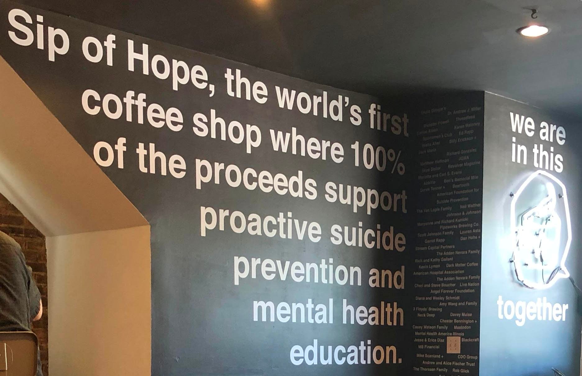 Wall text about proceeds supporting suicide prevention and mental health education