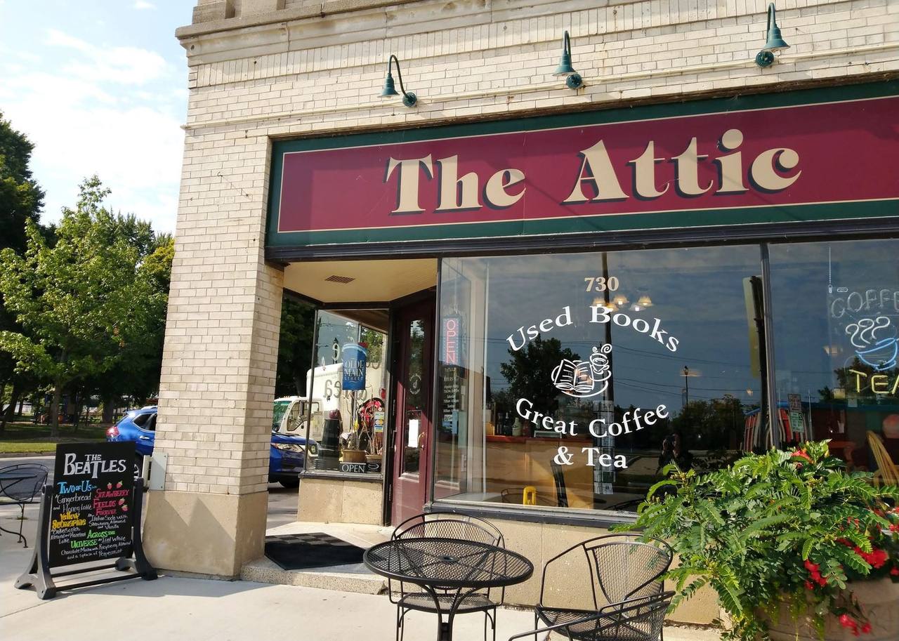 Brick corner storefront with window lettering for used books, coffee and tea
